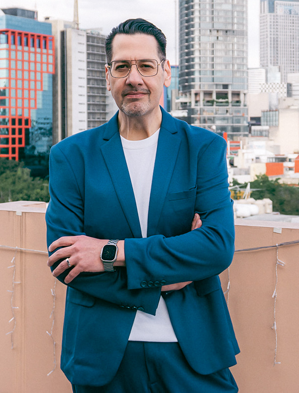 Founder of LD Collective Group standing on a rooftop in a blue suit